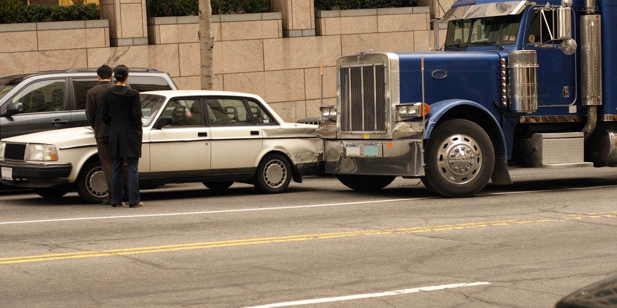 Car and semi tractor trailer in a fender bender in down town Washington DC. fleet managers