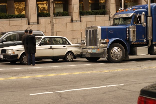 Car and semi tractor trailer in a fender bender in down town Washington DC. fleet managers