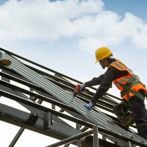 worker wear safety height equipment to install the roof. Fall arrestor device for worker with hooks for safety body harness, Worker as in the construction site