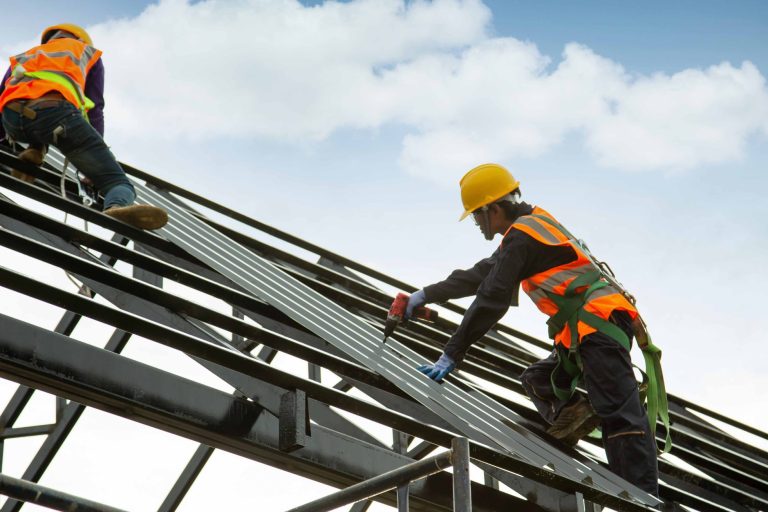 worker wear safety height equipment to install the roof. Fall arrestor device for worker with hooks for safety body harness, Worker as in the construction site