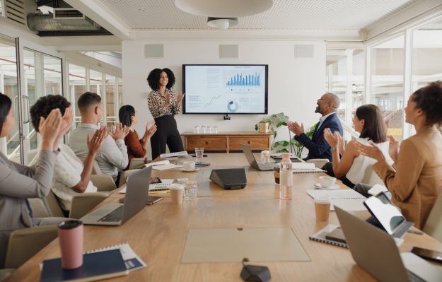 Business people, applause and presentation at conference with team in meeting, motivation or leadership at office. Group of happy employees clapping for proposal, collaboration or success at workshop