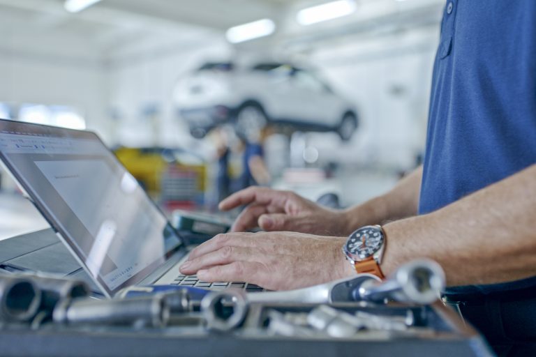 Hands Of Manager At The Auto Repair Shop Planning Operations Using Laptop